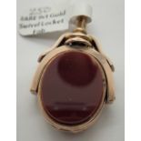 A rare 9ct yellow gold swivel fob, hinged and opens to reveal a locket, with carnelian and blood