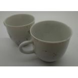 Two Nanking Cargo tea cups with worn black design, some damage