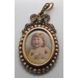 An unmarked gold (presumed 15ct) oval mourning locket, double sided with portrait of a young girl