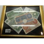 Five framed British banknotes