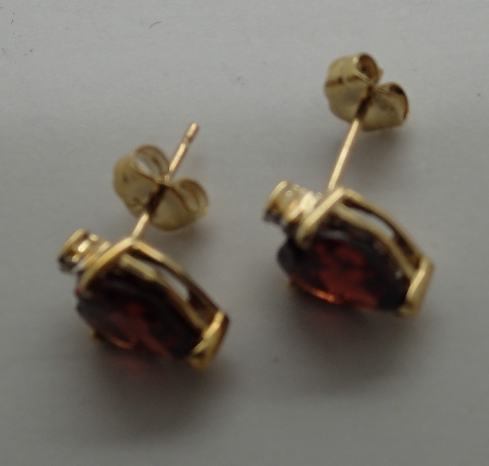 Pair of 9ct gold garnet and diamond earrings, never worn, 1.5g