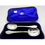 Hallmarked silver pair of serving spoons with rat tail design with presentation box, assay London