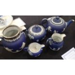 Wedgwood five piece blue jasperware tea set to include a milk jug, cream jug, sugar bowl etc