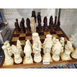 A resin animal chess set with wooden board, King H: 21cm