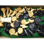 Box of wooden chess and draughts pieces