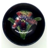 Moorcroft small footed bowl, tubeline decorated orchid on a blue ground, D: 11 cm. P&P group 1 (£