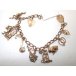 9ct gold charm bracelet with safety chain padlock clasp and 12 charms 20.1g. P&P group 1 (£16 for