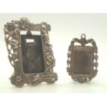 Two small photograph frames with stands, the smaller on unmarked, the larger one presumed silver.