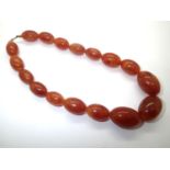 String of mottled amber beads largest L:31 mm in good condition 54g. P&P group 1 (£16 for the