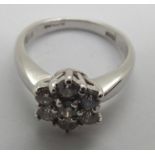 An 18ct white gold diamond flower head cluster ring totaling .75cts 4.9g, size K. P&P group 1 (£16