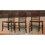 Three ladderback chairs with rush seats. This lot is not available for in-house P&P, please