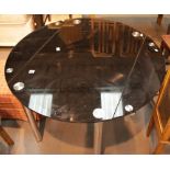 Circular glass dining table with removable side leaves, L: 192 cm. This lot is not available for