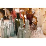Nine green glass bottles and other glass items. This lot is not available for in-house P&P, please