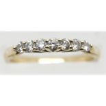 Unmarked yellow gold seven diamond ring, size M, 2.5g. P&P Group 1 (£14+VAT for the first lot and £