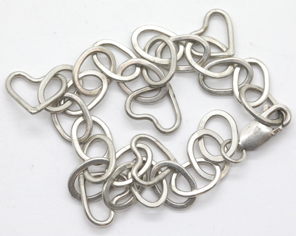 Silver vintage 1970s oval link bracelet with five heart charms. P&P Group 1 (£14+VAT for the first