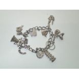 Vintage Silver Charm Bracelet with 10 charms 43g P&P group 1 (£16 for the first item and £1.50 for