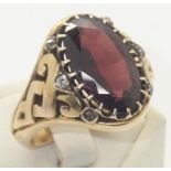 Vintage heavy gauge yellow metal presumed 18ct gold gents ring set with a large oval garnet and