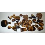 Loose gemstones: polished and natural tigers eye largest stone weighing 80.2cts, 24.4mm x 28.3mm