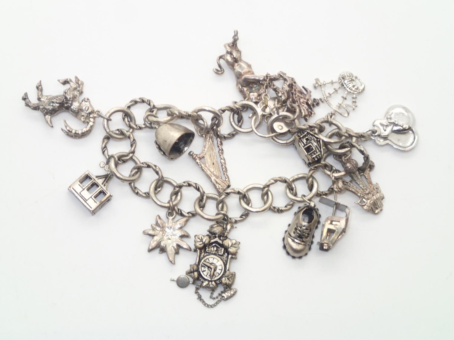 Vintage silver charm bracelet with 14 charms and padlock clasp, 45g P&P group 1 (£16 for the first