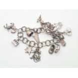 Vintage silver charm bracelet with 14 charms and padlock clasp, 45g P&P group 1 (£16 for the first