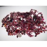 Loose gemstones: Large amount of garnets and garnet coloured stones, largest stone weighing 24.4cts,