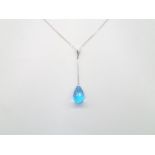 Contemporary 18ct white gold faceted blue topaz and diamond drop pendant on an 18ct white gold