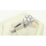 18ct white gold diamond flower head cluster ring, size K, 2.5g Shank marked total carat weight 0.