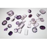 Loose gemstones: Amethyst and amethyst coloured stones, largest stone weighing 79cts, 23.3mm x 19.