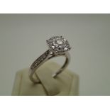 Contemporary 9ct white gold halo set diamond cocktail ring with diamond shoulders totalling 0.