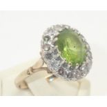 9ct gold cocktail ring set with a large peridot surrounded by diamonds, size R, 5.0g P&P group 1 (£