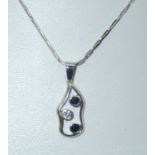 A contemporary 18ct white gold sapphire and diamond pendant on an 18ct white gold chain, 4.9g P&P