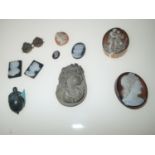 Various carved lava, agate and hardstone cameos, together with an antique carved lava acorn