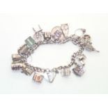 Heavy Vintage Silver Charm Bracelet with 18 charms. Includes £1 and 10 Shilling Notes and several