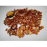 Loose gemstones: large amount of orange quartz and similar stones, largest stone weighing 19.4cts,