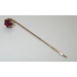 Presumed 9ct gold pin set with a single garnet P&P group 1 (£16 for the first item and £1.50 for