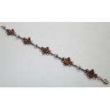 Gilt washed sterling silver, Baltic amber bracelet, also set with ruby and pearl type stones, L: