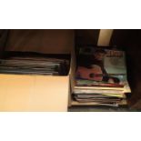 Two boxes of mixed LP and single records including some Elvis Presley compilations.This lot is not