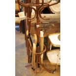 Small coat, hat and stick stand with four walking sticks. This lot is not available for in-house P&