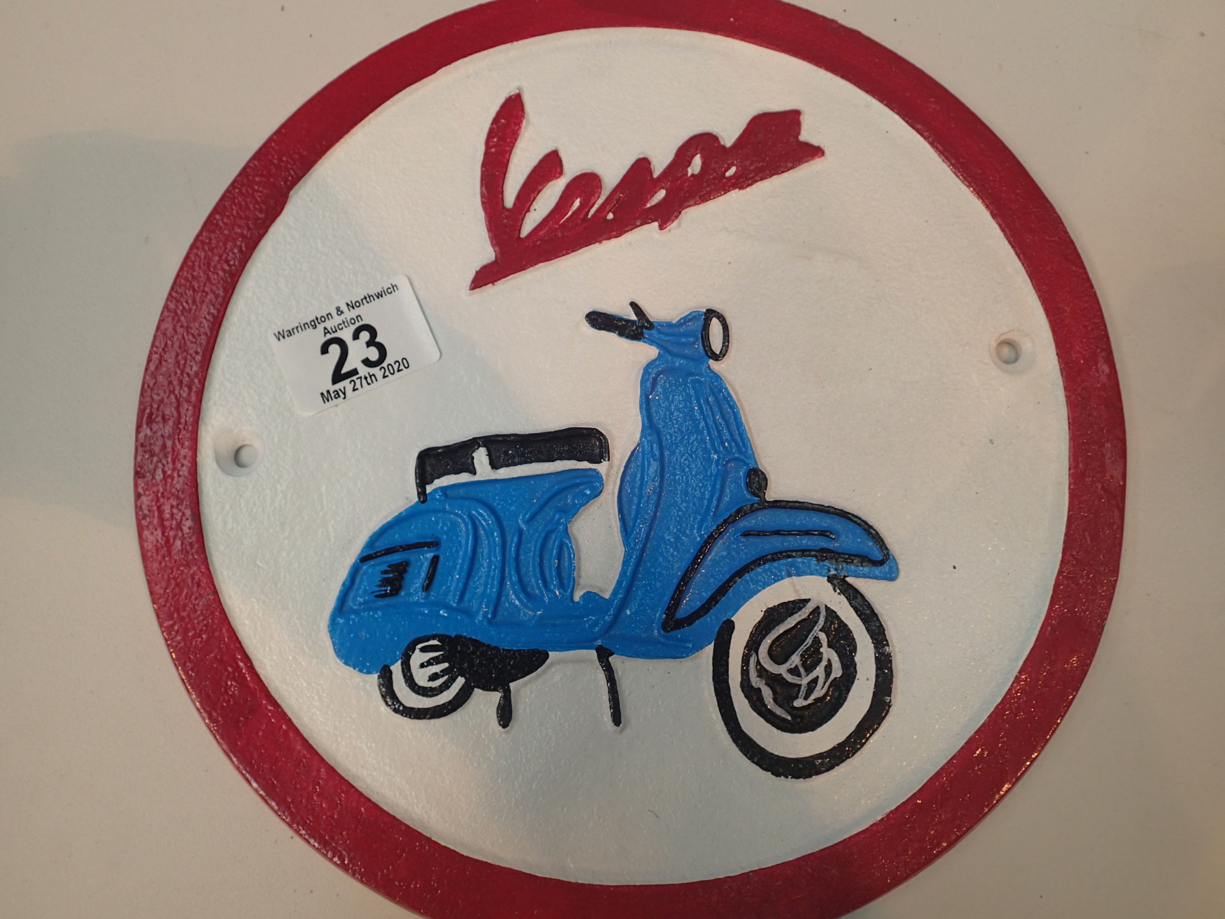 Cast iron metal sign of Vespa scooter D: 24 cm. P&P Group 2 (£18+VAT for the first lot and £2+VAT