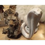 Cast resin tiger with cub and a ceramic hooded King Cobra model. This lot is not available for in-