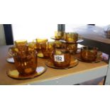 Collection of amber glass coffee cups and saucers. P&P Group 1 (£14+VAT for the first lot and £1+VAT