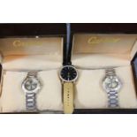 Two boxed fashion wristwatches and a watch head on partial strap. P&P Group 1 (£14+VAT for the first