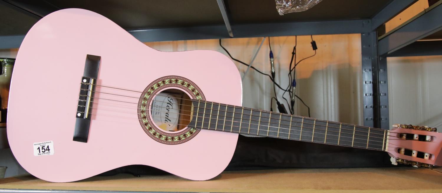 Cased pink six string Herald guitar. P&P Group 2 (£18+VAT for the first lot and £2+VAT for