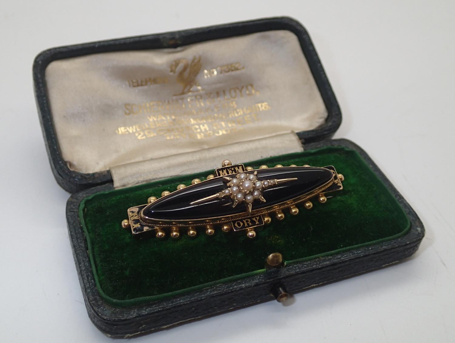 Boxed Georgian / Victorian presumed gold mourning brooch, enamelled with oval glazed panel to the