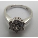 An 18ct white gold diamond flower head cluster ring totaling .75cts 4.9g, size K