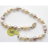 14ct gold mounted three-tone pearl bracelet with gold separators, L: 20 cm. Clasp is 14ct gold. P&