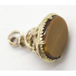 9ct gold fob set with an oval panel of tigers eye, 6.1g. P&P Group 1 (£14+VAT for the first lot