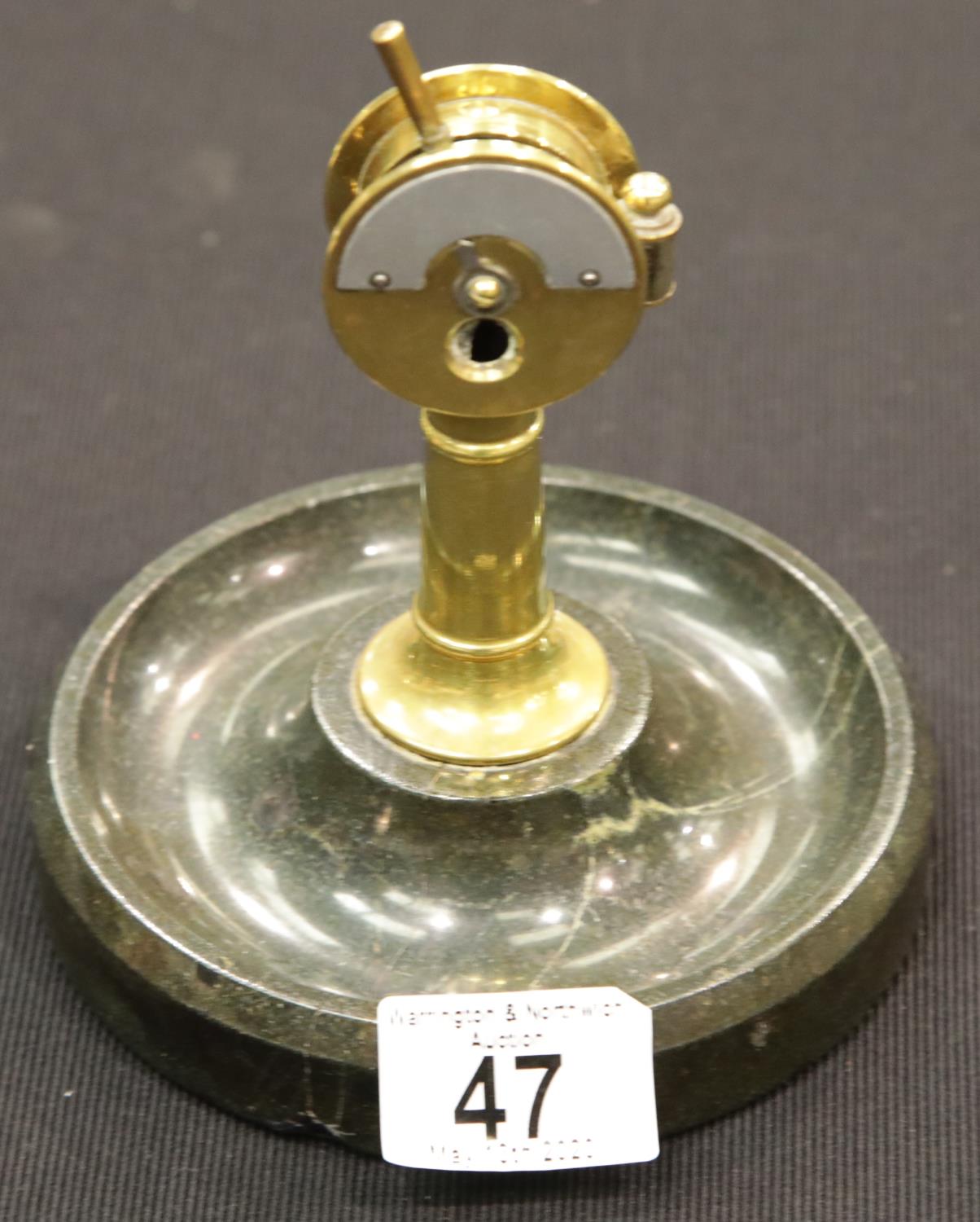 A brass desk cigar cutter in the form of a capstan, mounted on a circular marble base, H: 15 cm. P&P