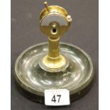 A brass desk cigar cutter in the form of a capstan, mounted on a circular marble base, H: 15 cm. P&P