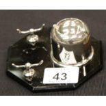 An Art Deco chromium inkwell with sprung cover and pen stand, mounted on an octagonal black glass